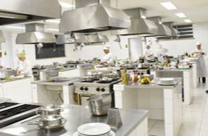 Laboratório de gastronomia com bancadas de inox e coifas